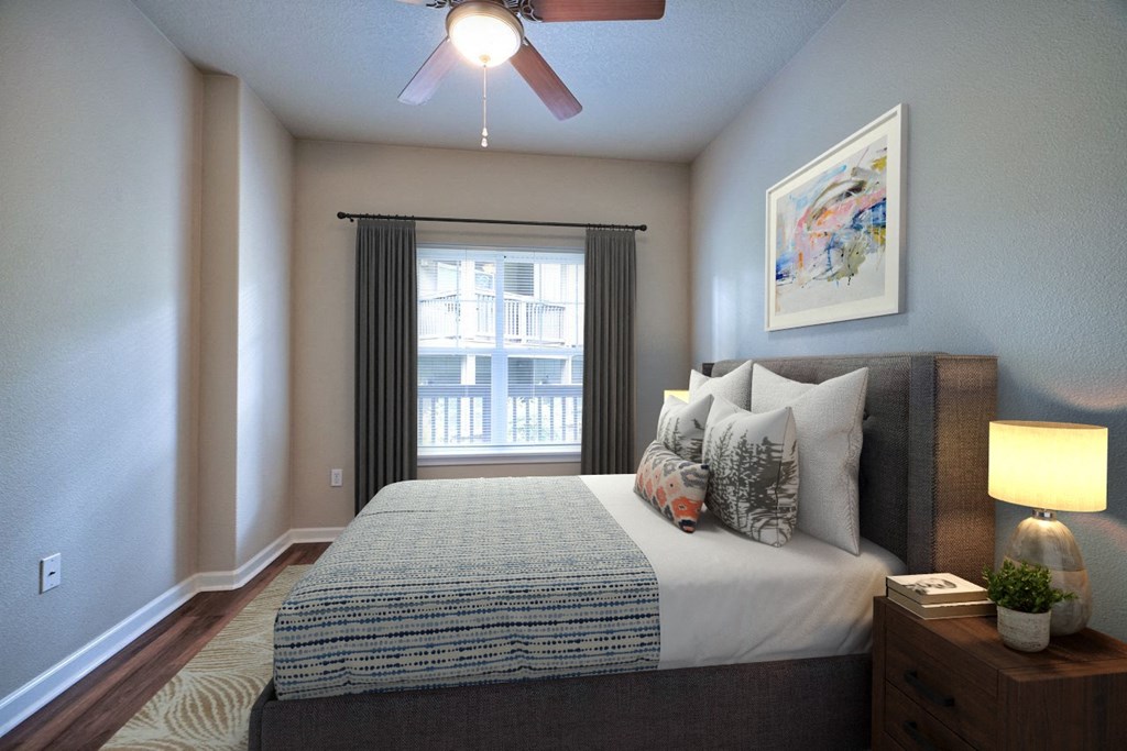 a bedroom with a bed and a ceiling fan