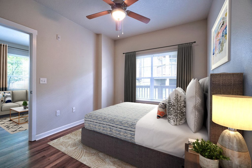 a bedroom with a bed and a ceiling fan