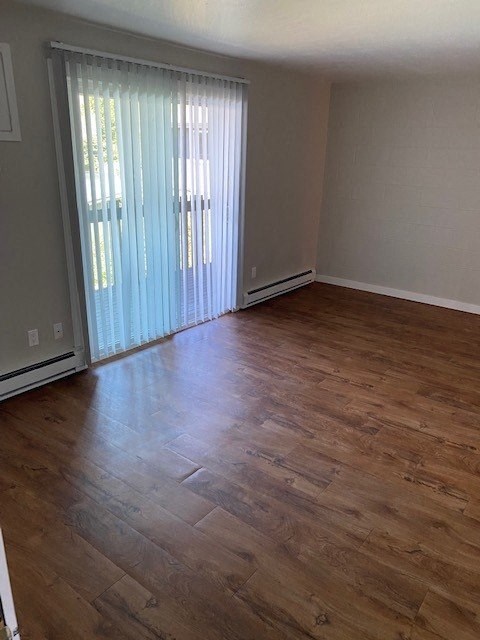 a living room with a wooden floor and a sliding glass door