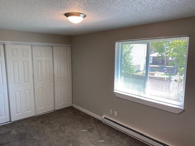 an empty room with a large window and two closets
