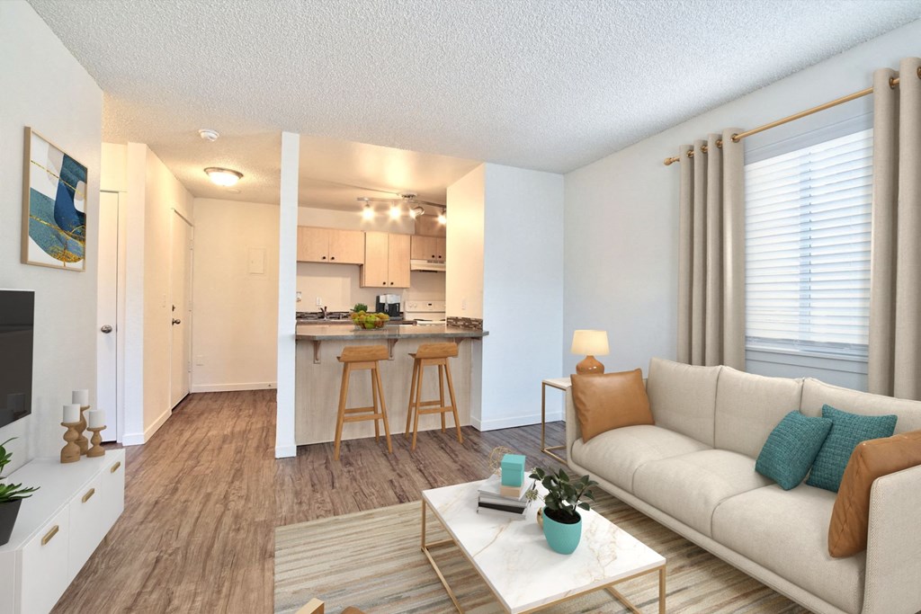 a living room and kitchen with a couch and a table