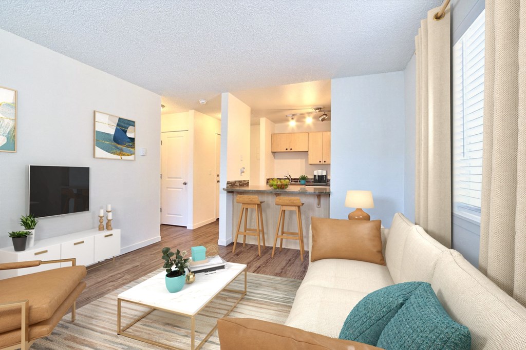 a living room and kitchen with a couch and a table