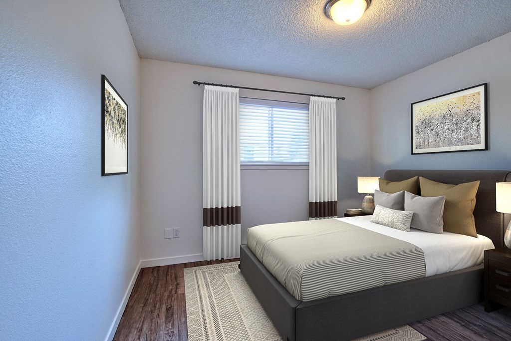 a bedroom with a bed and a window with curtains