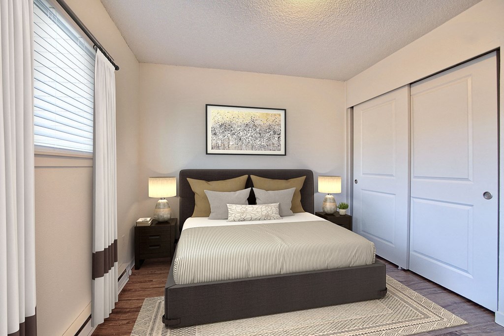 a bedroom with a large bed and a window