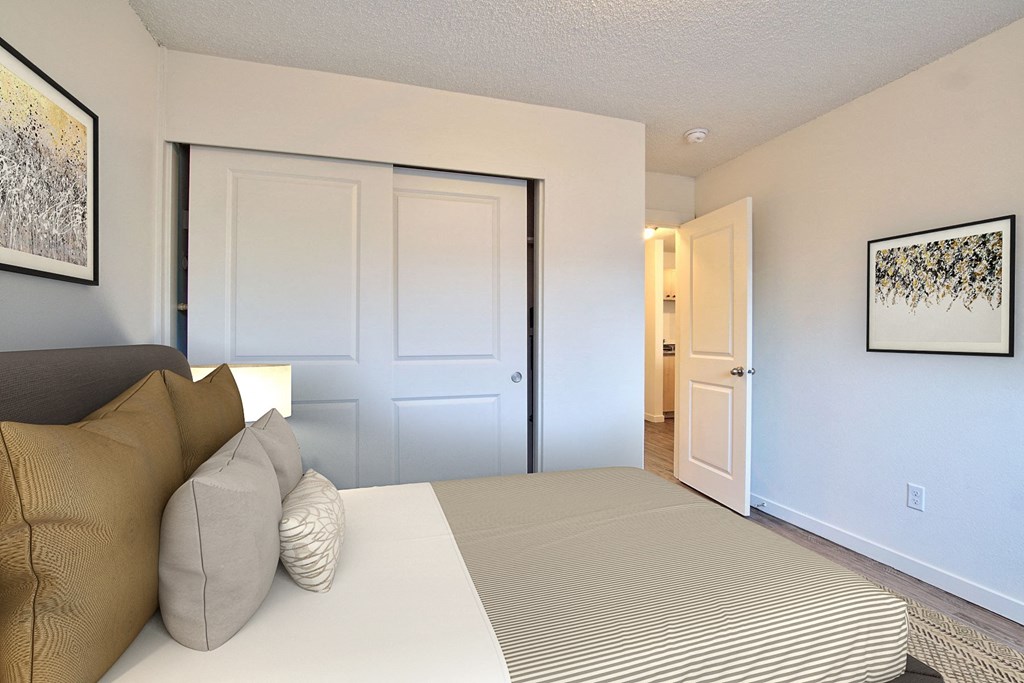 a bedroom with a large bed and a door to a bathroom