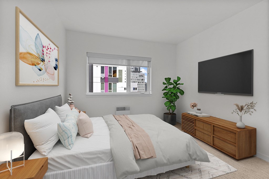 a bedroom with a large bed and a tv