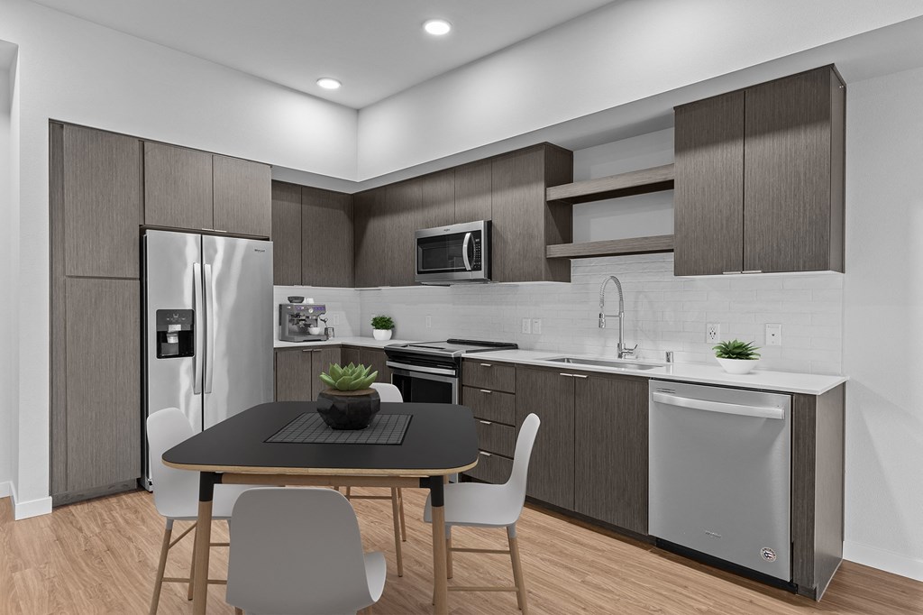 a kitchen and dining room with a table and chairs