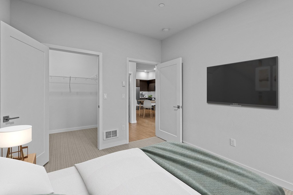 a bedroom with a bed and a tv