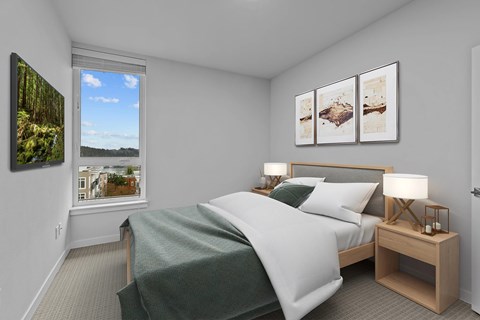 A bedroom with a large bed and a window overlooking a cityscape.