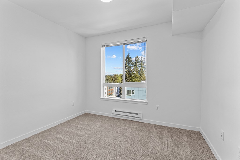 an empty living room with a large window