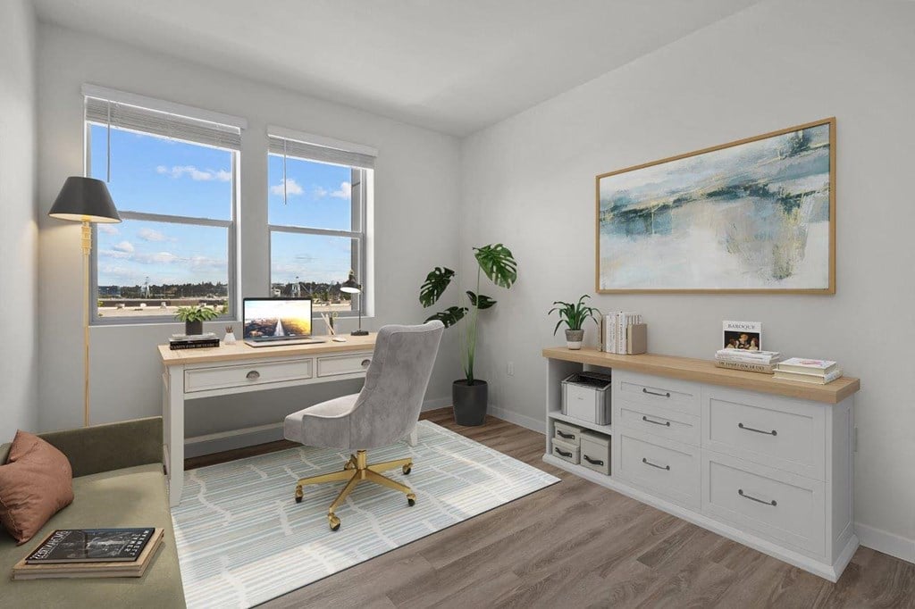 a home office with a desk and a window