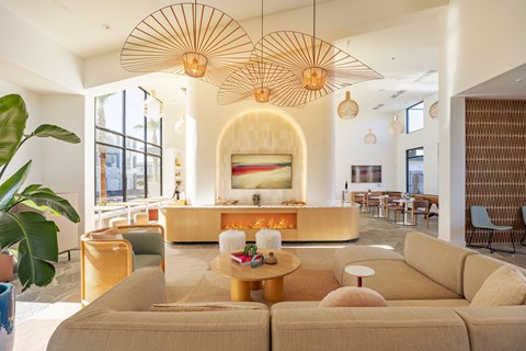 A living room with a large couch and a fireplace.