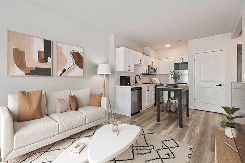 A modern living room with a white couch and a coffee table.