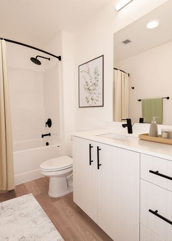 A white toilet sits in a bathroom next to a sink.