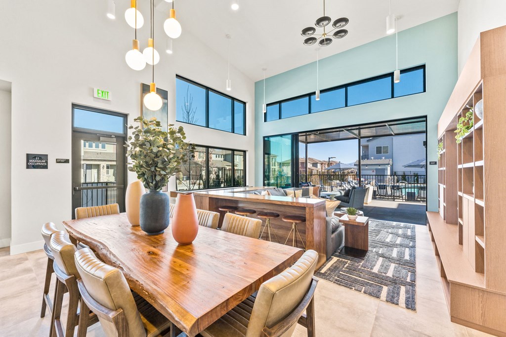 a dining room with a wooden table and chairs