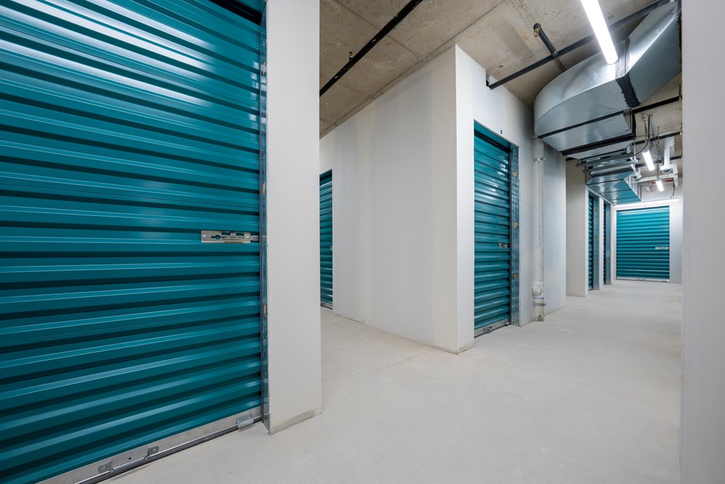 A storage unit with blue doors and white walls.