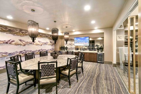 a dining room with a table and chairs and a kitchen