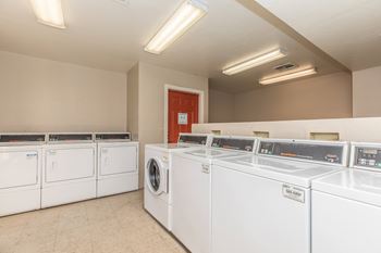 A row of washing machines in a laundromat.