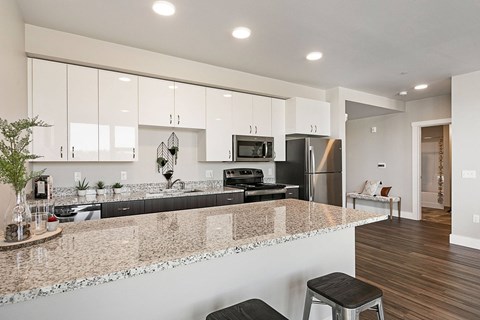 an open kitchen with an island and a counter top