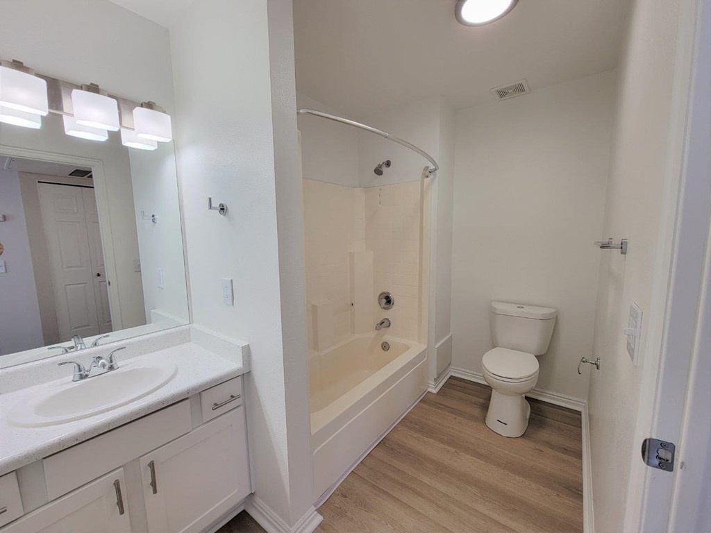 a bathroom with a toilet and a sink and a tub