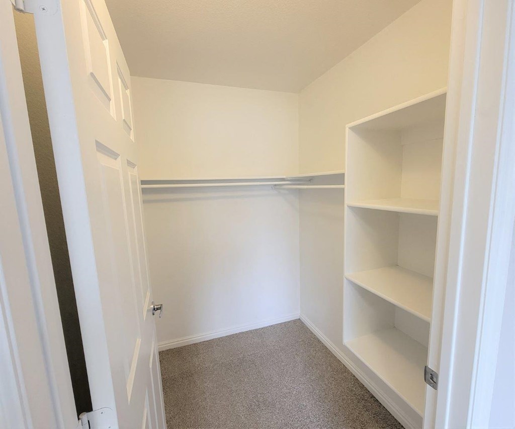 a empty closet with shelves and a door