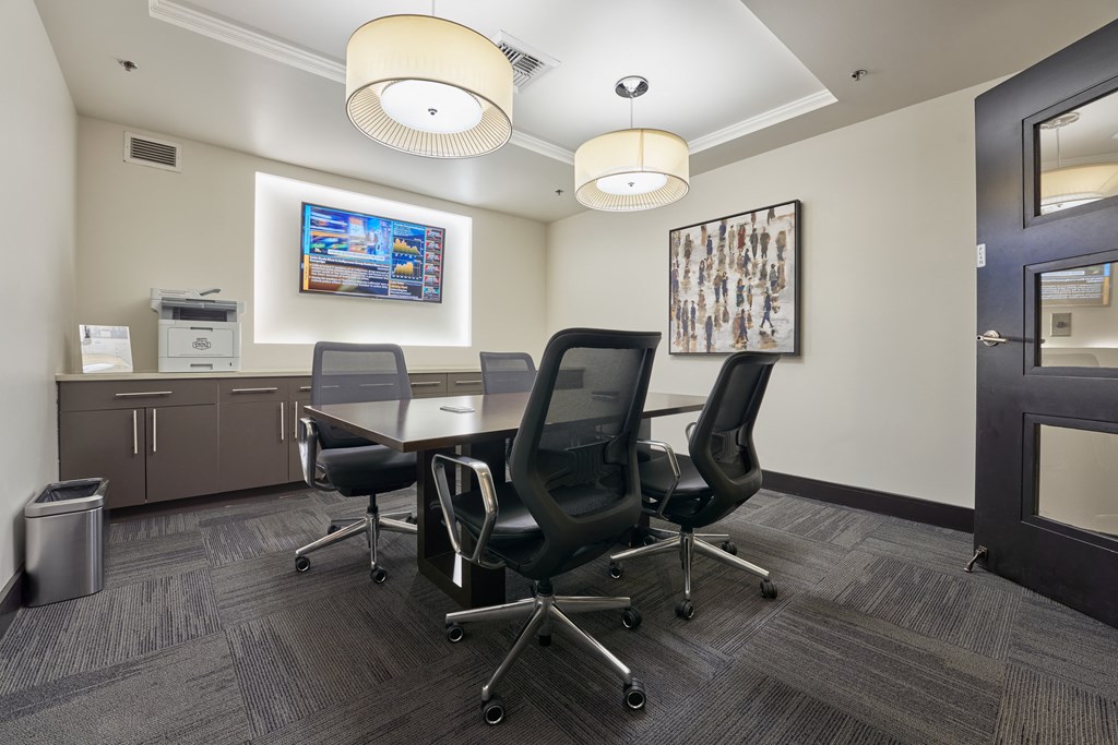 a conference room with a table and chairs