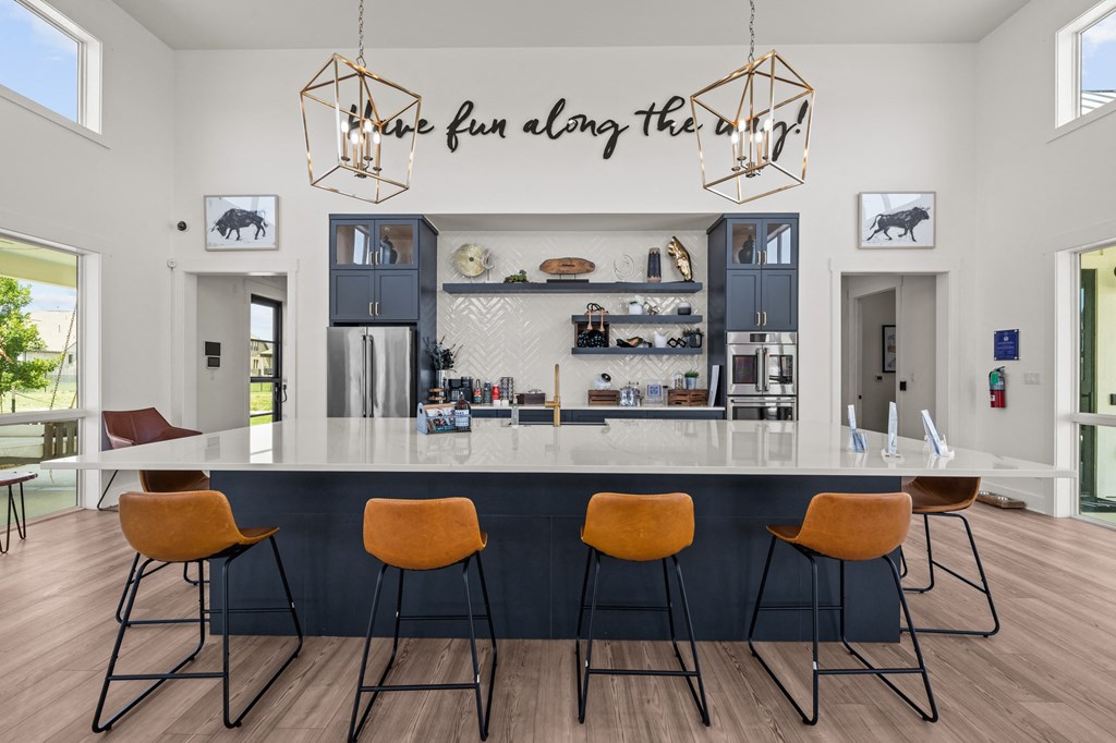 a kitchen with a counter top and four chairs