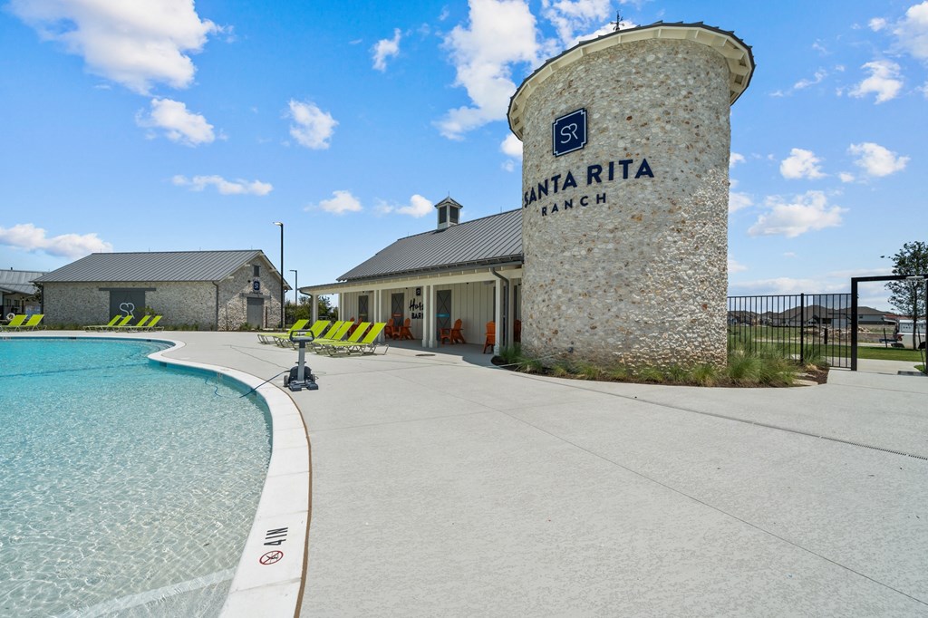 a swimming pool with a building and a water tower