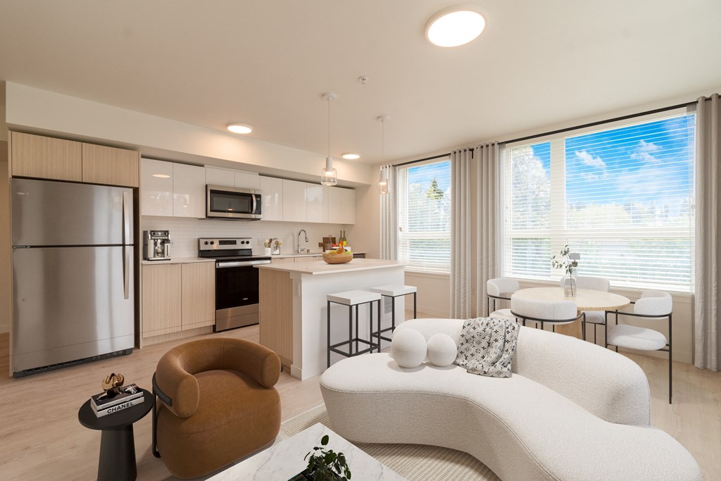 an open kitchen and living room with a couch and a table