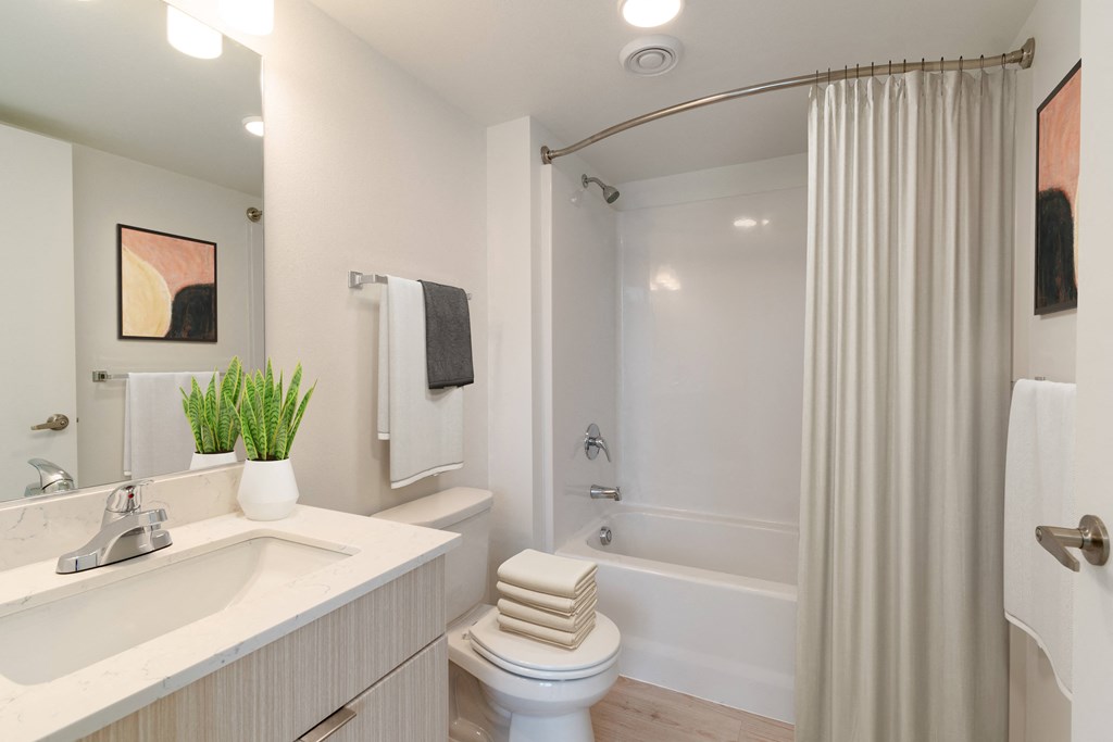 a bathroom with a sink toilet and a shower