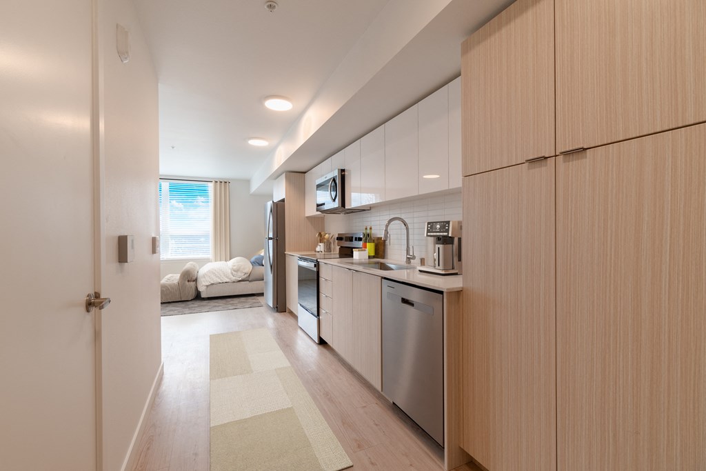 a kitchen with white cabinets and stainless steel appliances