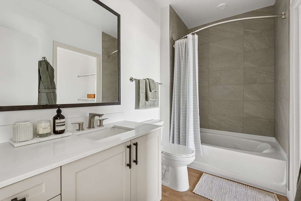 A bathroom with a white tub and sink.