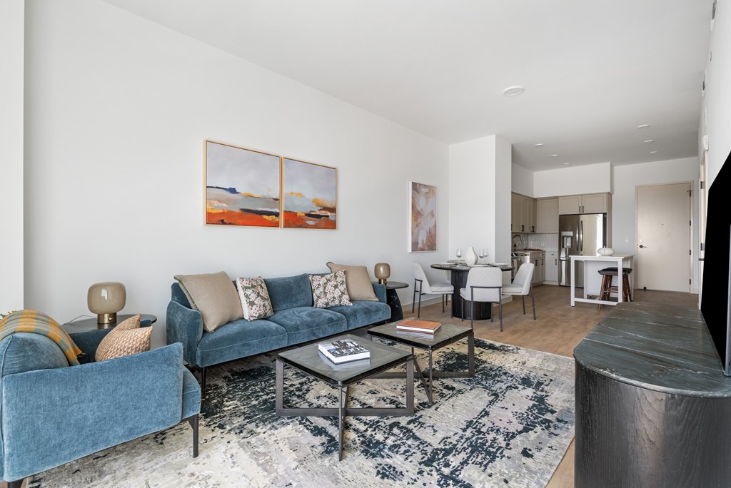 A living room with a blue couch and a coffee table.