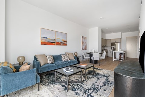 A living room with a blue couch and a coffee table.