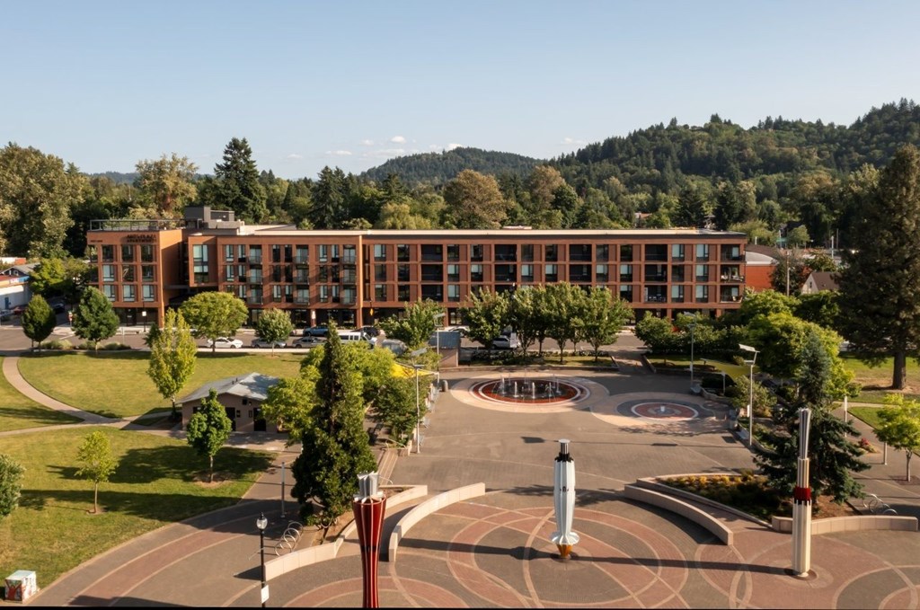 Arts Plaza Gresham Oregon Apartments building exterior with parking and courtyard.