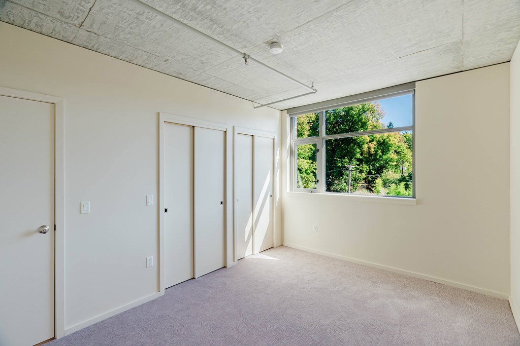 Empty room with white walls and carpet.