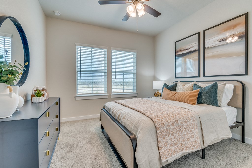 a bedroom with a large bed and a ceiling fan