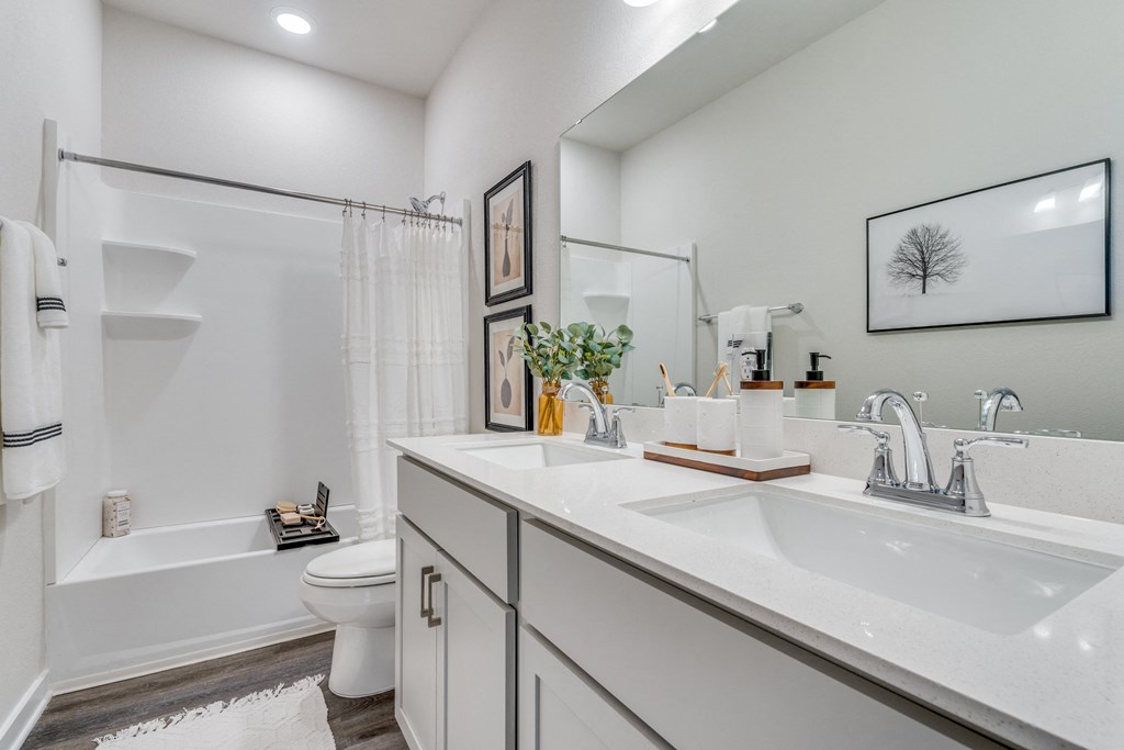 a bathroom with a sink and a shower and a toilet