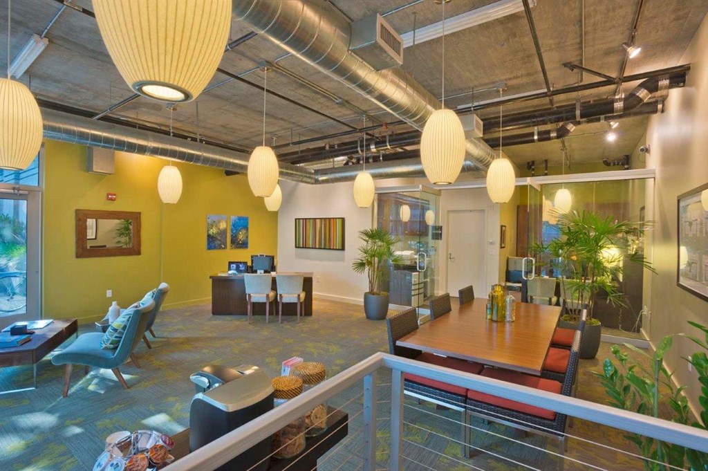 A modern office space with yellow walls and a glass railing.