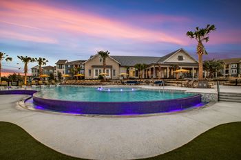 A large house with a pool in front of it.