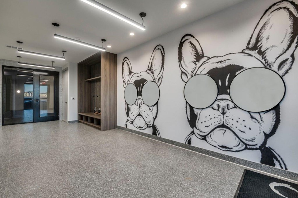 A hallway with a large mural of a dog's face on the wall.