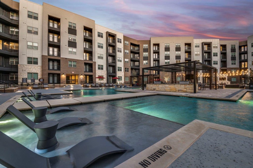 A modern building with a pool and a "No Diving" sign.