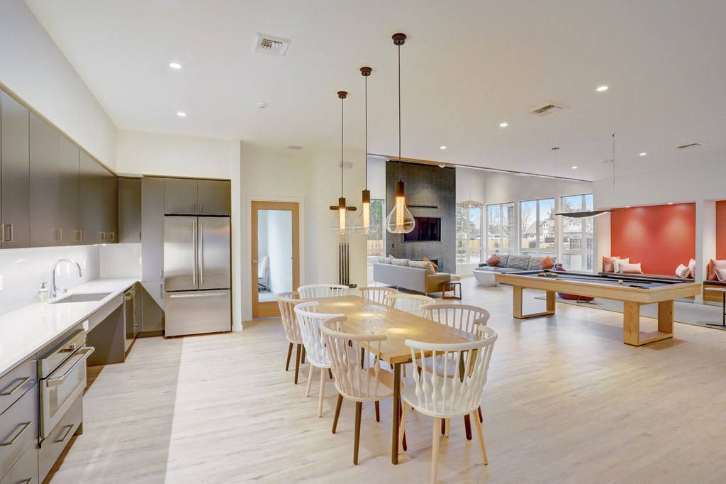 a kitchen and dining room with a table and chairs