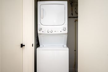 A white washing machine in a small room.