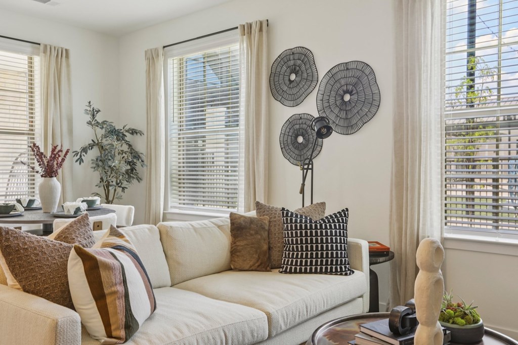 A living room with a white couch and a coffee table.