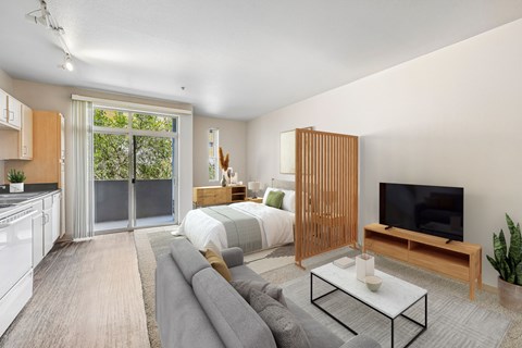 A modern living room with a grey sofa and a television.