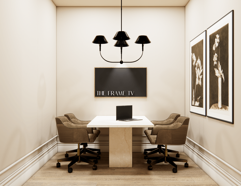A meeting room with a table, chairs, and a sign that says "The FRAME TV".