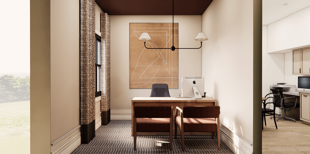 A room with a desk and chairs with a painting on the wall.