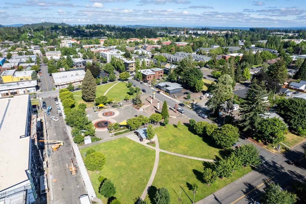 Arts Plaza Gresham Oregon Apartments neighborhood A view of a town from above, with buildings, roads, and a park visible.