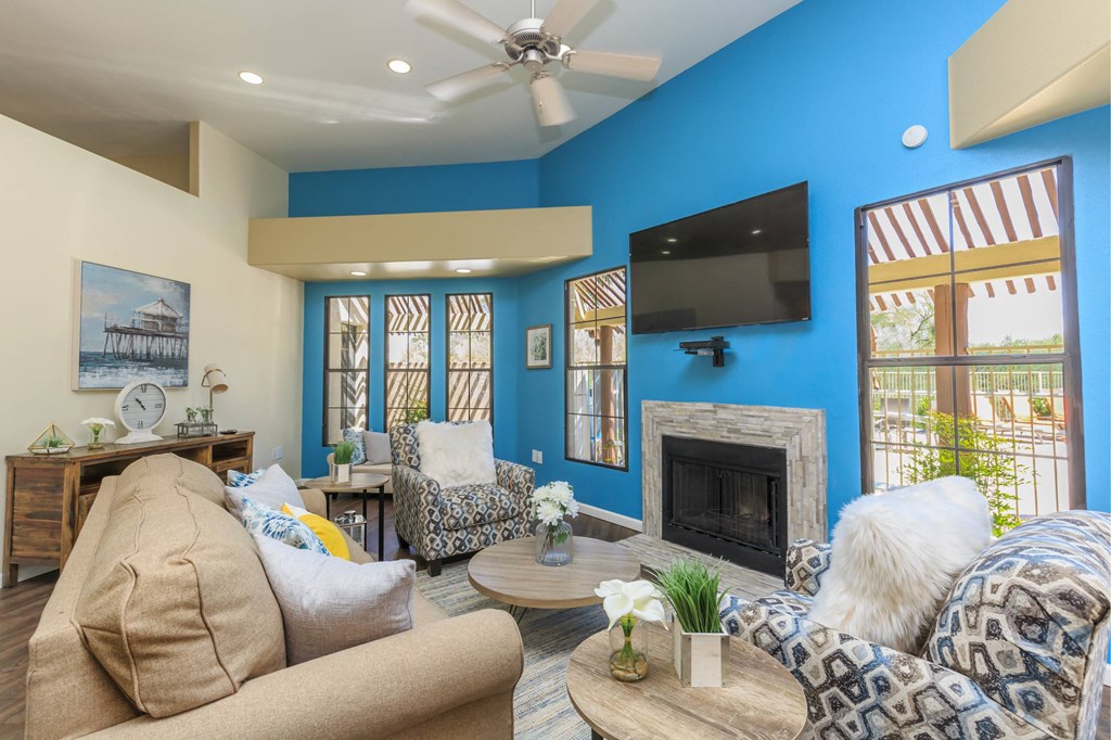 A living room with a fireplace and a television on the wall.